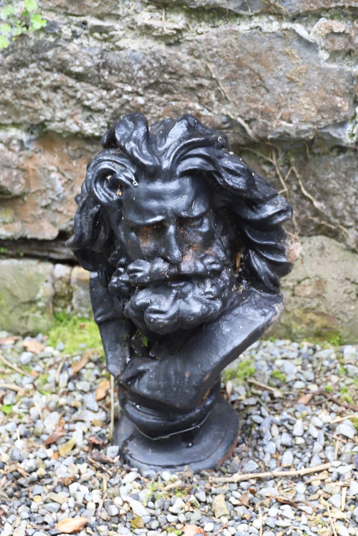 CAST IRON GREEN MAN GARDEN MASK: Cast iron Green Man mask with flowing beard and foliate features, finished in black paint.