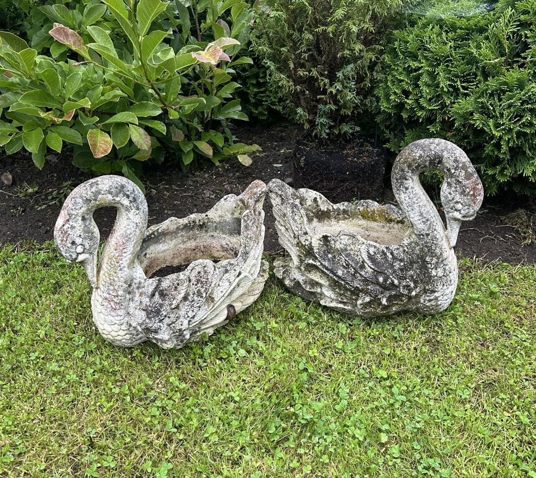 PAIR OF COMPOSITE STONE SWAN PLANTERS: Pair of composite stone swan-form planters with shaped bowls and weathered surface patination.