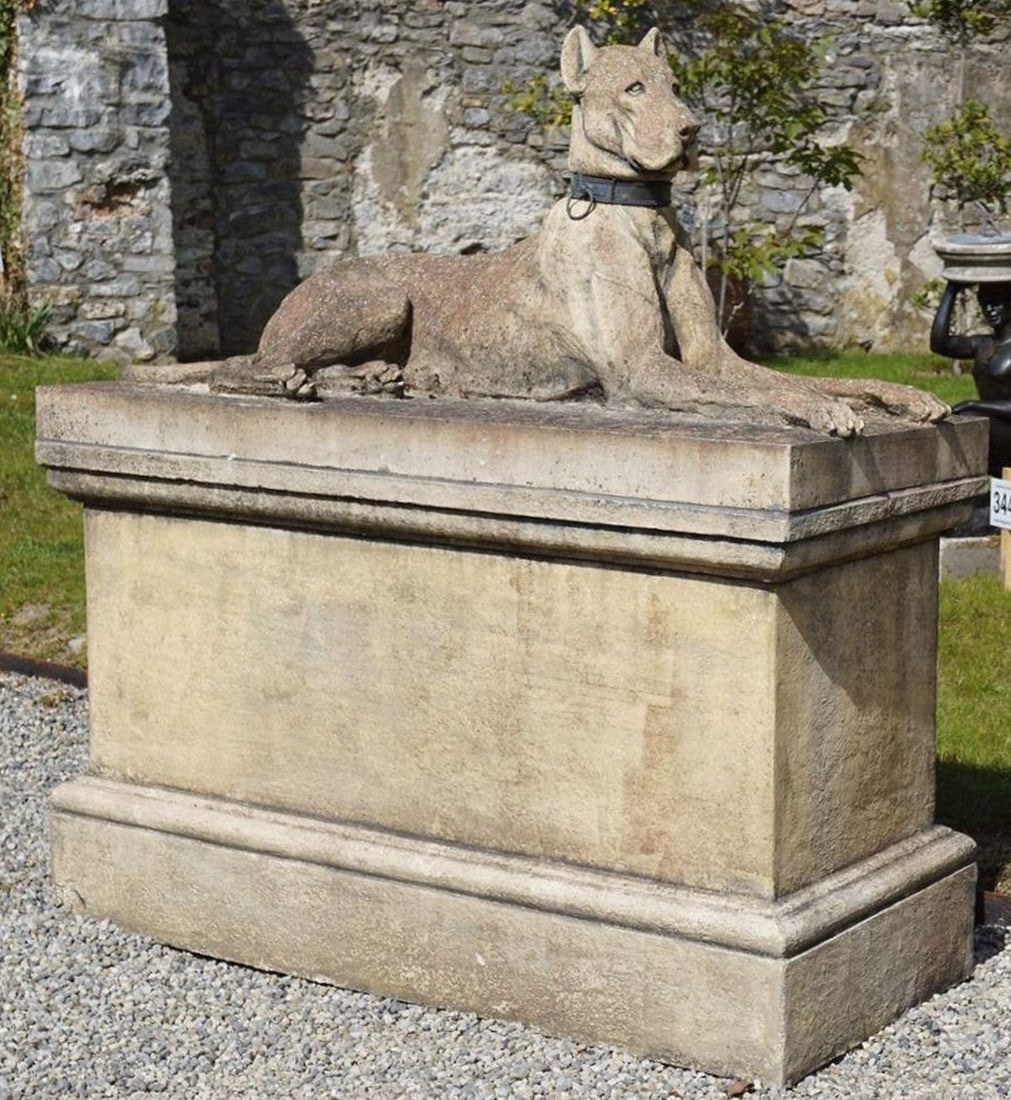 PAIR OF STONE SCULPTURES OF KINSALE HOUNDS: ON RECTANGULAR BASES, pair of stone sculptures depicting Kinsale hounds, each shown reclining on a rectangular base. Well-carved with poised expressions and smooth stylised form.