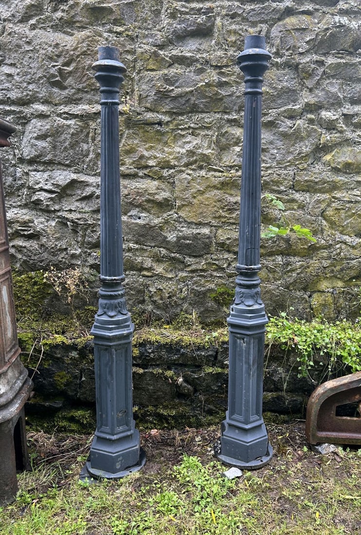 PAIR OF CAST IRON LAMP POSTS: A matching pair of cast iron lamp posts with fluted shafts and moulded bases, retaining later painted finish.