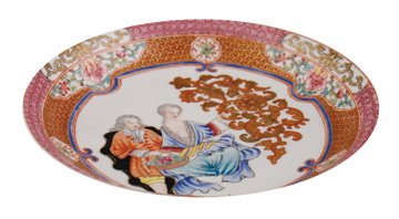 Eighteenth-century Chinese famille rose export saucer,: painted with a European gentleman bringing a basket of flowers to a seated lady, clasping a large sinuous gilt floral spray, the rim with a pink cell diaper border