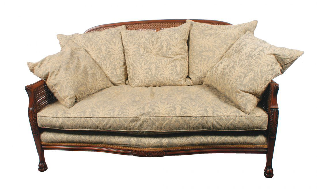 Pair of Edwardian bergere settees: Pair of Edwardian bergere settees each with loose cushions, raised on claw feet to the fore each 140 cm. wide