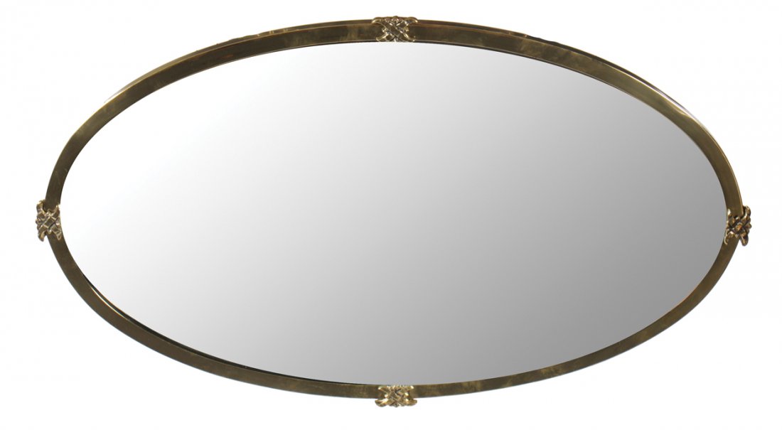 Edwardian brass framed oval bevelled mirror: Edwardian brass framed oval bevelled mirror 60 cm. wide