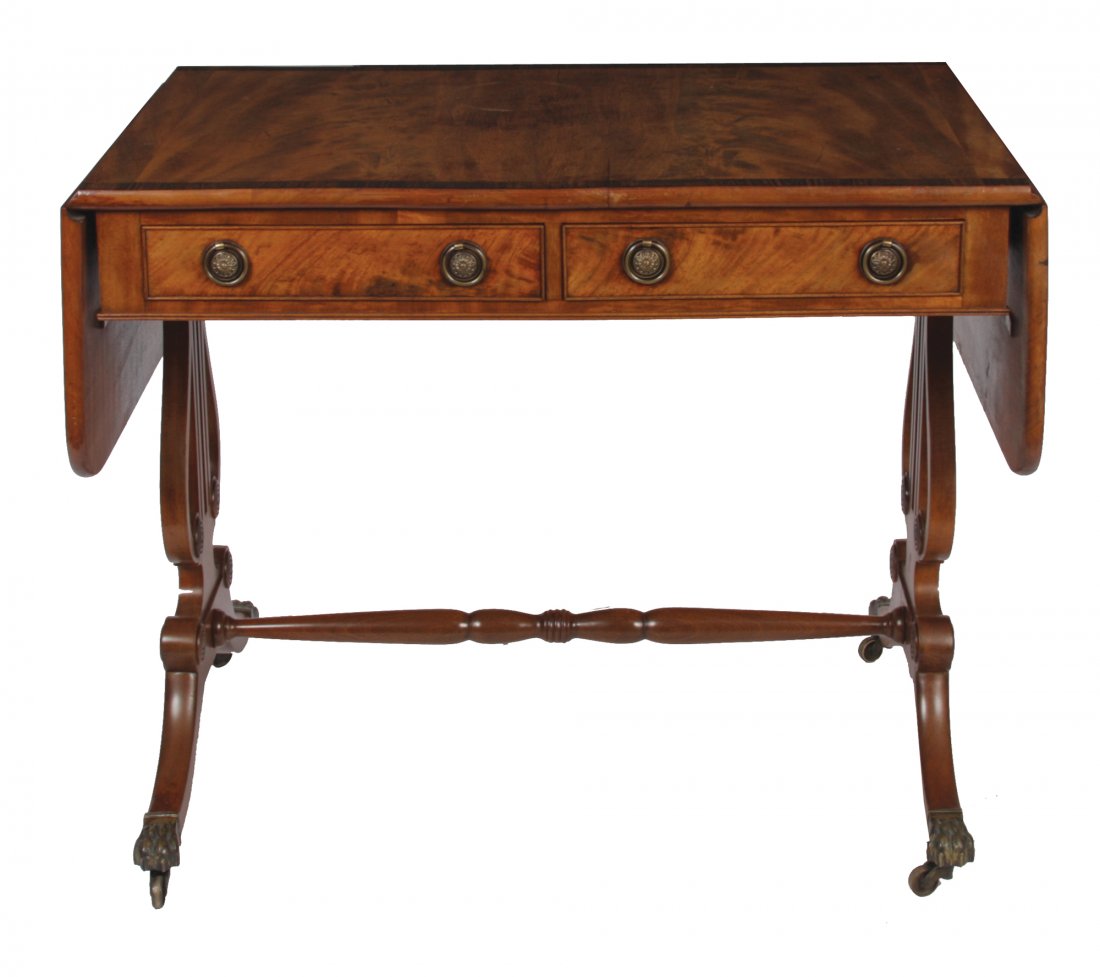 Regency style mahogany and crossbanded sofa table: Regency style mahogany and crossbanded sofa table with drop leaves, raised on lyre and sabre ends, terminating on brass claw feet 95 cm. wide