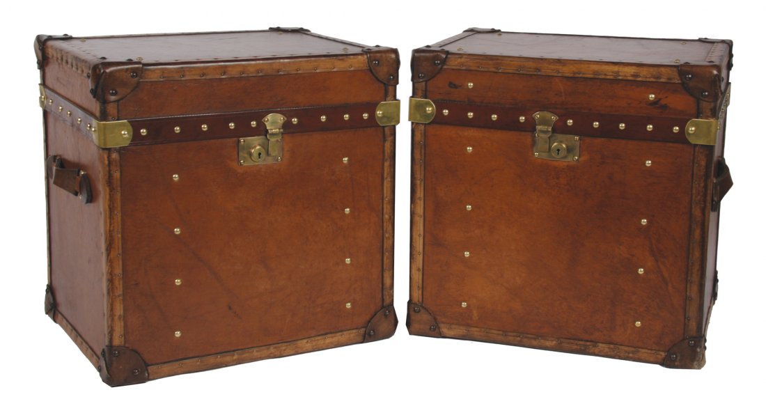Pair of leather bound trunks: Pair of leather bound trunks each of square form 50 cm. wide; 50 cm. high