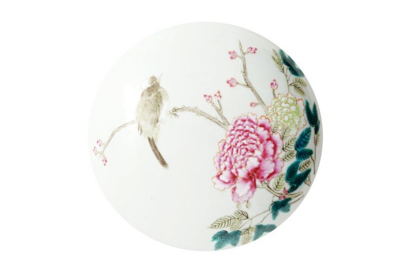 A Chinese famille rose circular lidded box, reign mark: The lid painted with a bird perched on a peony spray, the box sides with further peony sprays and butterflies, a six-character reign mark of Guangxu to the base in overglaze red. This box is made part
