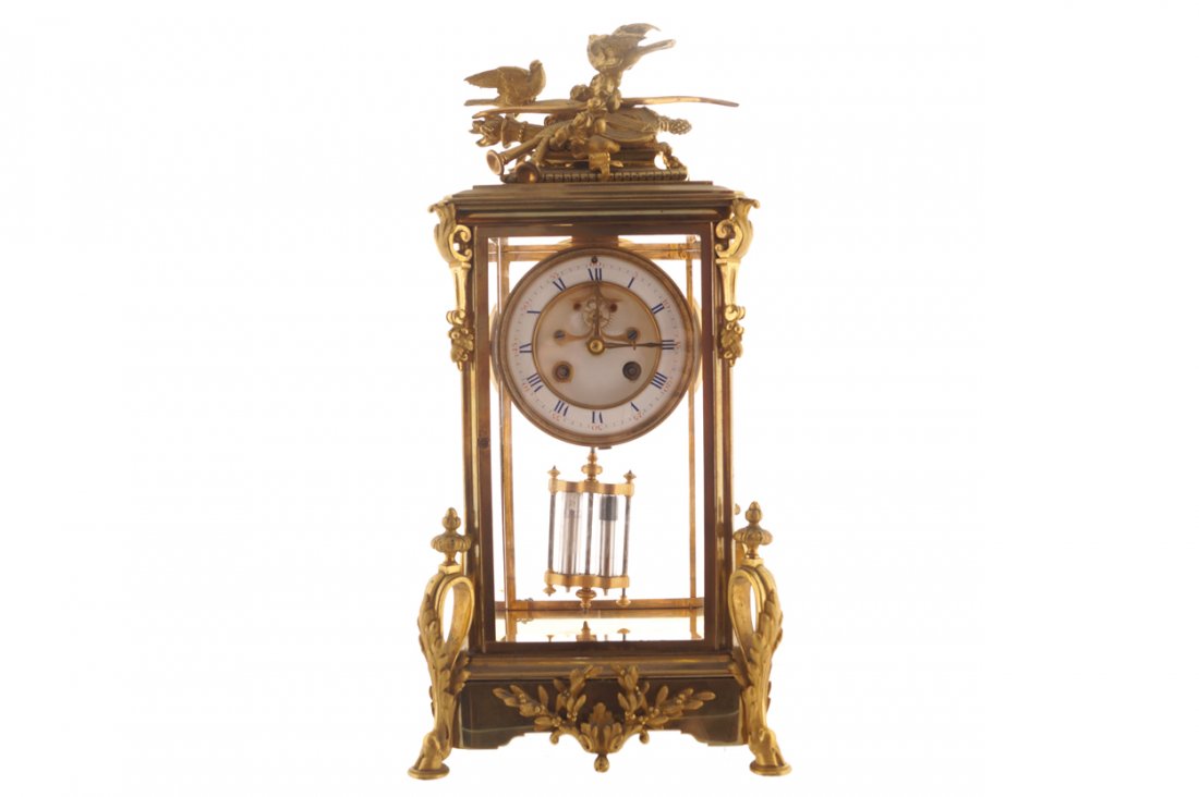 Nineteenth-century brass framed mantel clock: Nineteenth-century brass framed mantel clock ‘J. Marti Paris', of square form, surmounted by a trophy of musical instruments, a torch and birds Worldwide shipping available. All queries must be made