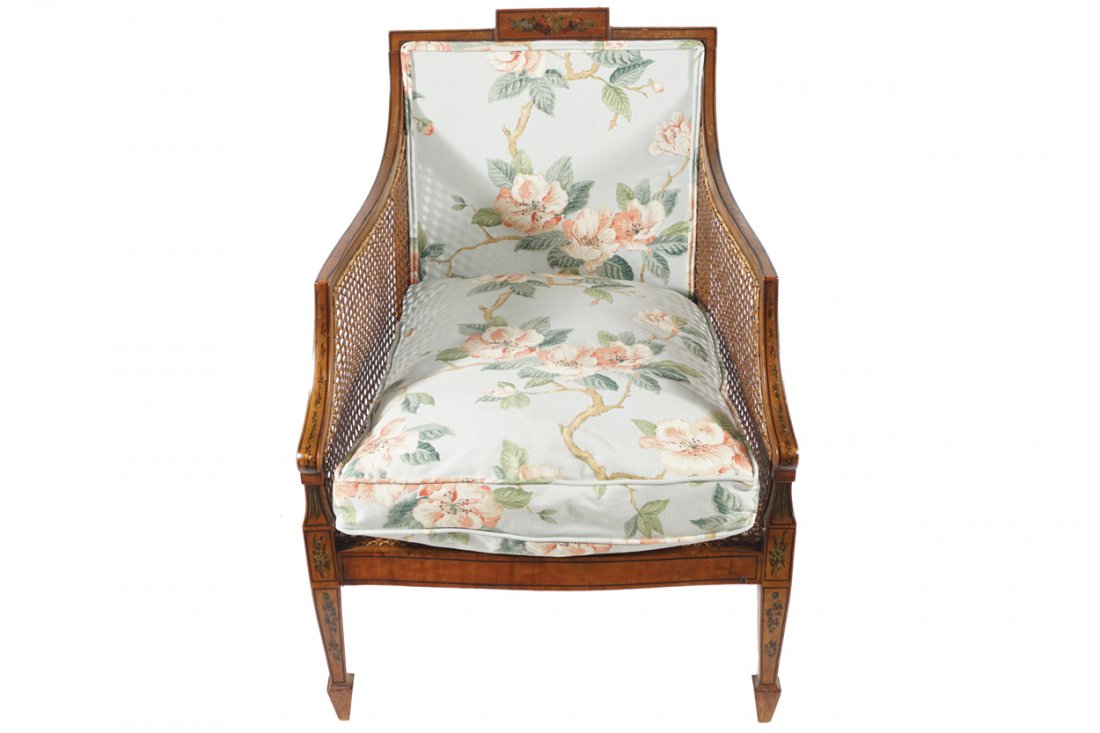 PAIR OF EDWARDIAN SATINWOOD AND PAINTED BERGERE CHAIRS: PAIR OF EDWARDIAN SATINWOOD AND PAINTED BERGERE CHAIRS each with loose cushions, raised on square tapered legs, terminating on spade feet Dimensions: 86 cm. high; 60 cm. deep; 63 cm. wide