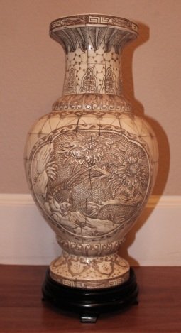 HAND CARVED BONE VASE: ANTIQUED HAND CARVED BONE VASE ON STAND - EXCELENT CONDITION - MINT - BIRD DESIGN ADORNS FRONT AND BACK - WOOD BASE/ STAND - 18.75" X 9" X 9"