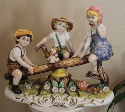 RARE CAPODIMONTE - CHILDREN ON SEE-SAW - PORCELAIN SCUL: RARE CAPODIMONTE - 3 CHILDREN AND DOG ON SEE-SAW - HAND PAINTED PORCELAIN SCULPTURE - 22"H X 23"W X 9" - MADE BY CAPODIMONTE ITALY