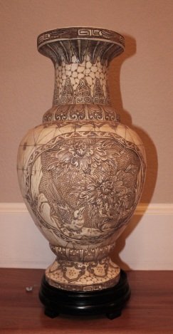 HAND CARVED BONE VASE: ANTIQUED HAND CARVED BONE VASE ON STAND - EXCELENT CONDITION - MINT - BIRD DESIGN ADORNS FRONT AND BACK - WOOD BASE/ STAND - 18.75" X 9" X 9"