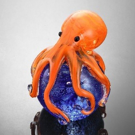 ART GLASS OCTOPUS SPHERE / PAPERWEIGHT: ART GLASS ORANGE OCTOPUS SPHERE / PAPERWEIGHT - 4"H X 3"W X 3"D - HAND CRAFTED - EACH PIECE IS MADE BY HAND THEREFOR THERE MAY BE SLIGHT VARIATIONS WITHIN EACH INDIVIDUAL PIECE