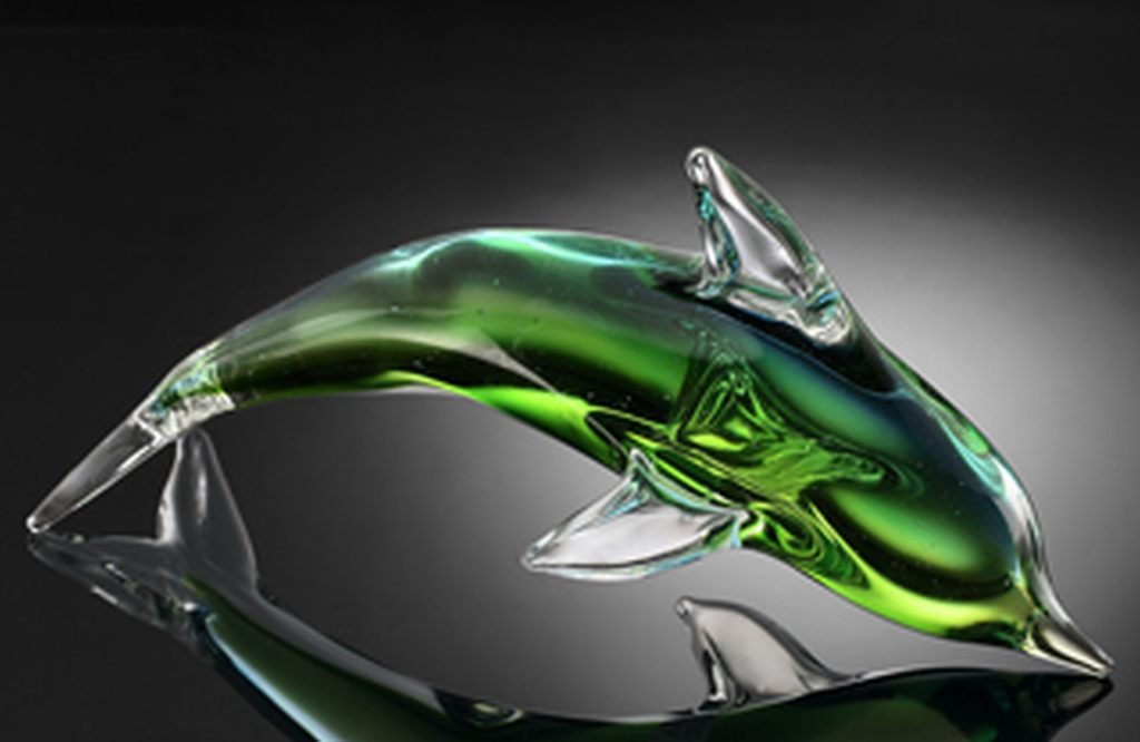 ART GLASS GREEN DOLPHIN: BEAUTIFUL GREEN ART GLASS DOLPHIN - 7"H 12"W 4"D - HAND CRAFTED - EACH PIECE IS MADE BY HAND THEREFOR THERE MAY BE SLIGHT VARIATIONS WITHIN EACH INDIVIDUAL PIECE