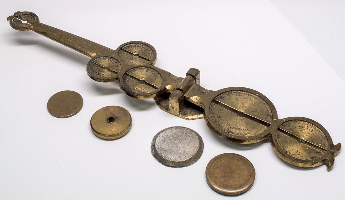 Allender Gold Coin Counterfeit Detector/ Scale -: 1855 A brass rocker scale manufactured and patented on Nov. 27, 1855 by John Allender. It measures 8.5â€ in length on a brass pivot base. The scale has marked circular pans for placing coins of $20