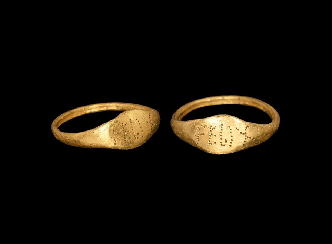 Roman Ring with FELIX: 1st-3rd century AD. A gold child's ring with flat section band widening to the shoulder; flat bezel engraved with FELIX. 0.97 grams, 13.34mm overall, 8mm internal diameter (1/2"). Ex Amphora Coins, Lo