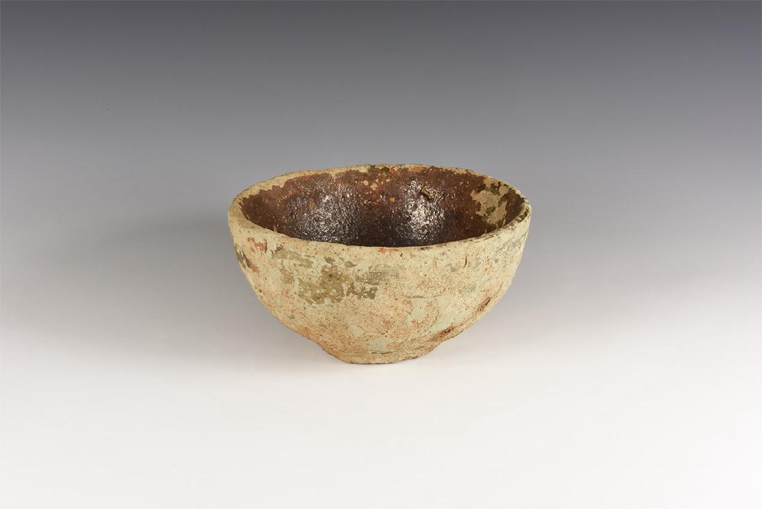 Byzantine Shipwreck Bowl: 12th-13th century AD. A ceramic salt glazed bowl with thick walled body, small foot; brown glaze to the inside of bowl, traces of pale green to outside. 625 grams, 14.5cm (5 3/4"). Property of an Esse