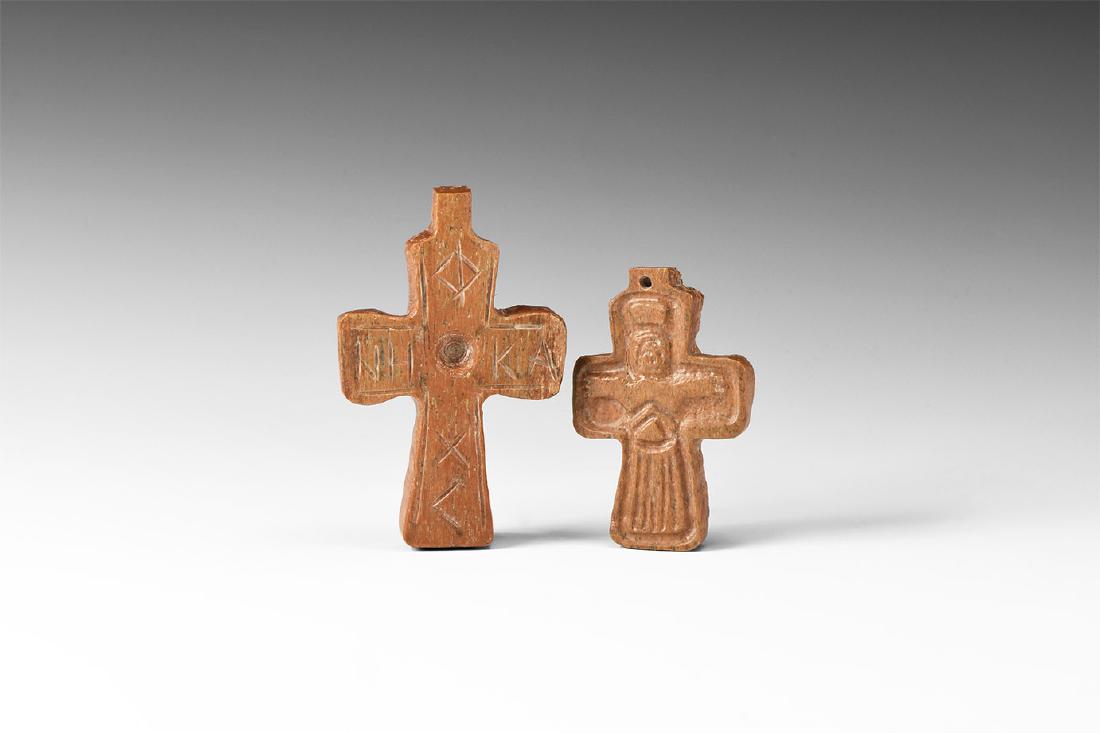 Byzantine Cross Pendant Group: 10th-13th century AD. A group of bone cross pendants comprising: one with low-relief carved Corpus Christi, pierced lug above; one with central socket, 'NHKA' and '??<' legends, pierced lug above. 34 