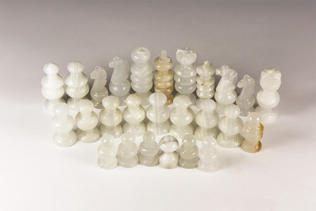 Mixed Carved Chess Set Piece Group: 20th century AD. A mixed group of turned agate chess men. 692 grams total, 31-66mm (1 1/4 - 2 3/4"). Property of a Hampshire collector; from Mexico. [26, No Reserve]