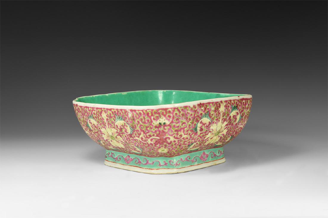 Chinese Enamelled Octagonal Footed Bowl: 19th century AD. A ceramic footed bowl, square with fluted corners, green inner face and outer dense design of pink tendril and flowers, chop seal to the underside. 1.7 kg, 22cm (8 1/2"). From the Tan