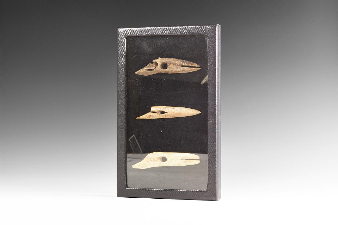 North American Inuit Eskimo Harpoon Head Group: 4th millennium BC. A group of three bone harpoon heads, comprising: one leaf-shaped in smooth cream bone with mounting hole and slot to the point, marked 'BAA' and 'BOMBRA'; one similar in roughened b