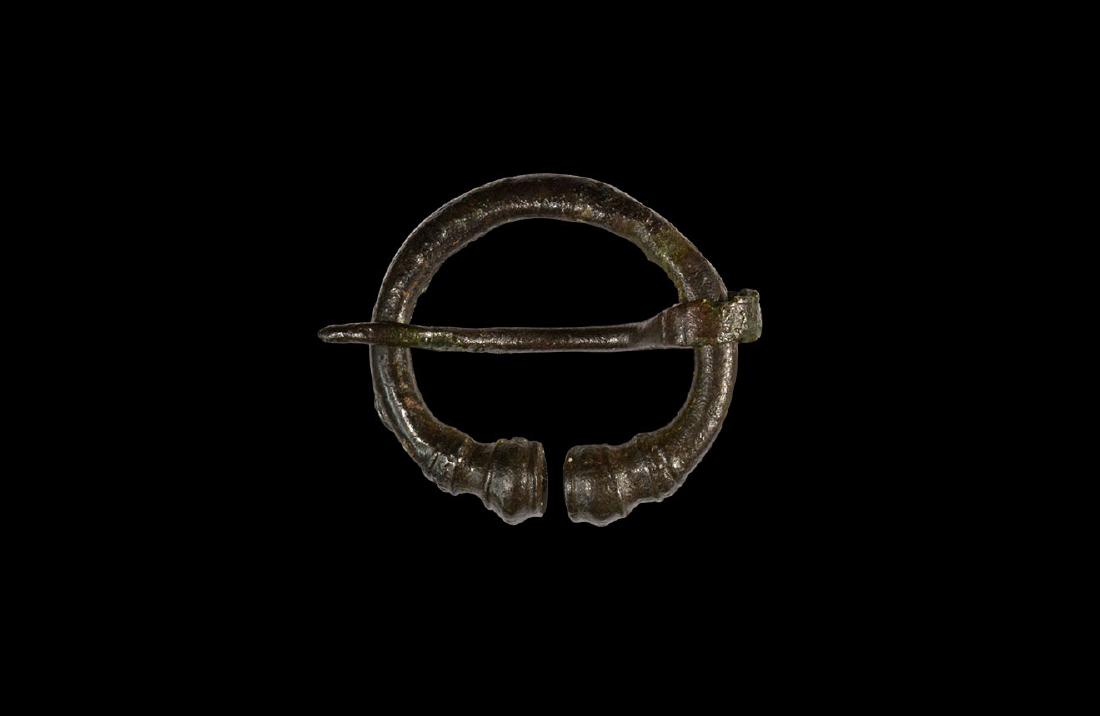 Romano-Celtic Neck Torc Type Brooch: 1st century AD. A bronze round-section penannular brooch with rilled and balustered terminals, round-section pin with flat end coiled about the shank. Cf. Hattatt, R. Brooches of Antiquity, Oxford, 19