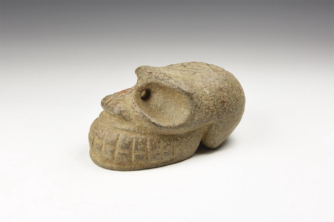 Chinese Carved Skull: An undated archaistic limestone weight formed as a stylised skull with mask to the top of the cranium, pierced at the eye sockets for suspension. 1.14 kg, 12.5cm (5"). From a large London collection;
