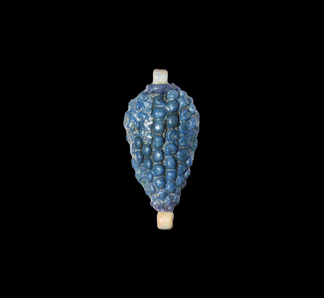 Egyptian Grapes Amulet: Amarna Period,1353-1336 BC. A pale blue glazed composition amulet in the form of a bunch of grapes; with integral suspension loop to the top and bottom. See Andrews, C. Amulets of Ancient Egypt, Londo