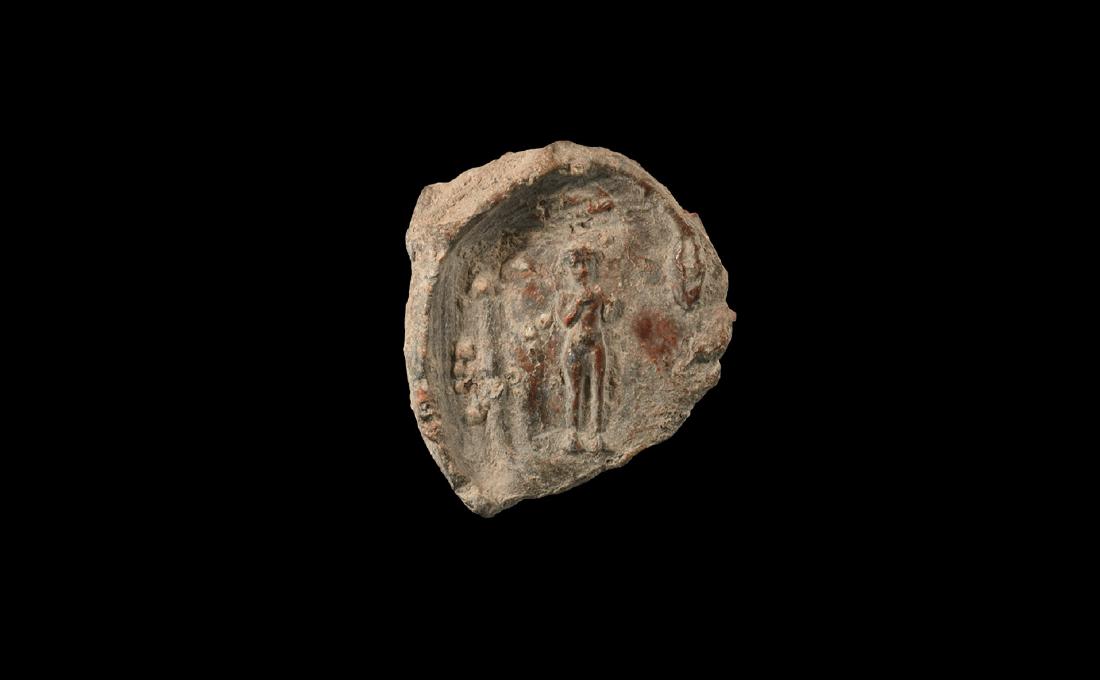 Egyptian Seal Impression with Harpokrates.: Roman Period, 30 BC-323 AD. A lead discoid seal impression with high-relief image of a standing god Harpokrates with his finger to his mouth. 16 grams, 29mm (1 1/4"). Property of a European collecto