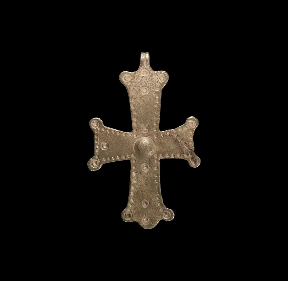 Byzantine Silver Cross Pendant: 7th-12th century AD. A silver cross of the 'Armenian' type, with short cross arms and each warm with a roundel to the corner of each arm; punched hole decoration to the border and central boss; suspen