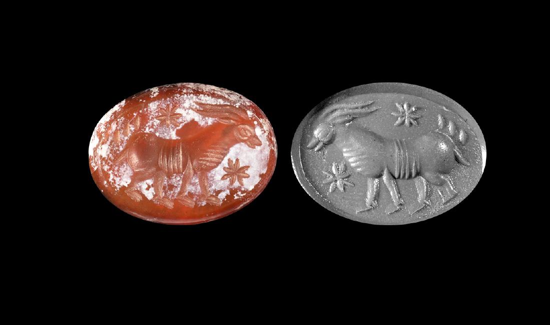 Western Asiatic Sassanian Intaglio with Ibex: 3rd-7th century AD. A flat discoid carnelian appliquÃ© with intaglio image of an ibex standing in profile. 1.57 grams, 20mm (3/4"). Property of a London gentleman; acquired before 1980.