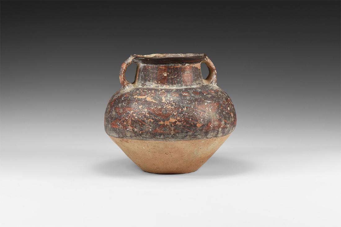 Native American Pueblo Vessel: 17th century AD. A ceramic vessel with flared rim, short neck with panels of red and brown pigment; globular body with geometric pattern in red pigment, unglazed buff colour to the lower section; shor