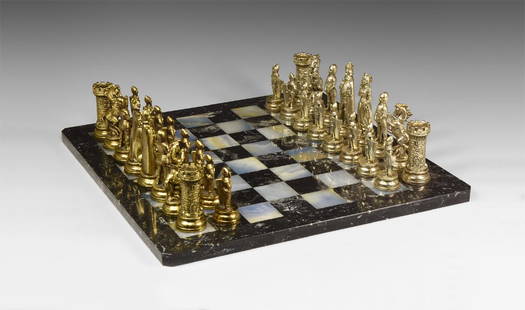 Vintage 'Medieval' Style Chess Set: 20th century AD. A chess set comprising a polished stone board, hollow-cast metal chessmen in medieval-style costume and armour. 12.5 kg total, board: 40 x 40cm (15 3/4 x 15 3/4"). Property of an Esse