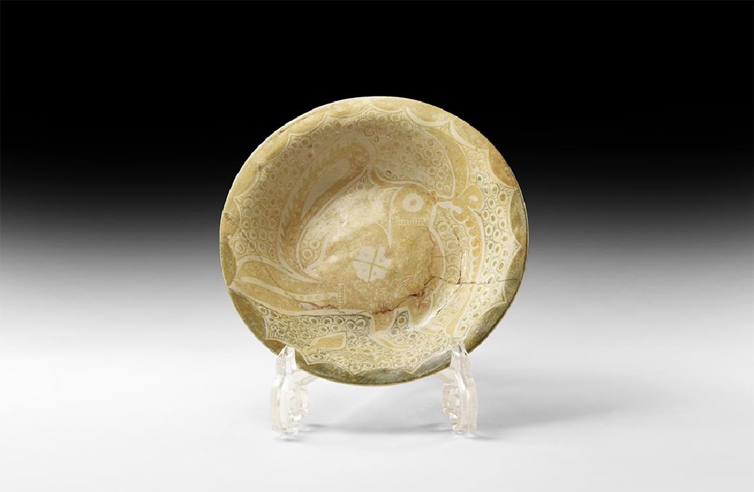Islamic Samanid Glazed Dish with Bird: 10th-11th century AD. A ceramic bowl with slightly flared rim, decorated to the inside with a large guinea fowl in ochre colours with tail raised and large eye, foliage to the beak; to the background 