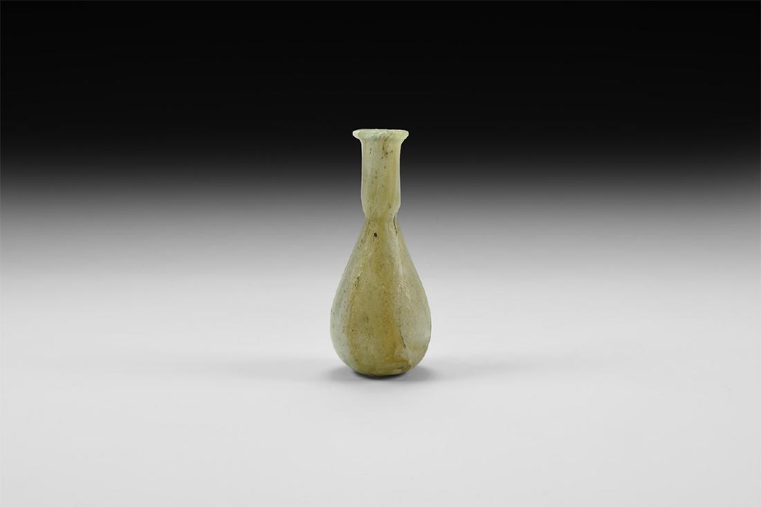 Roman Marbled Glass Unguentarium: 1st century AD. An iridescent green glass unguentarium with piriform body, tubular neck with everted rolled rim. Cf. Whitehouse, D. Roman Glass in the Corning Museum of Glass, vol.1, New York, 1997, i