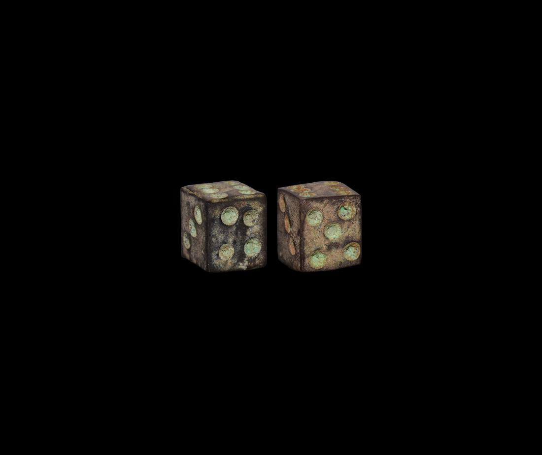 Roman Bronze Dice Pair: 1st-3rd century AD. A matched pair of bone dice with ring-and-dot markings distributed 1:6, 2:3, 5:4. See Allason-Jones, L. & Miket, R. The Catalogue of Small Finds from South Shields Roman Fort, Newc