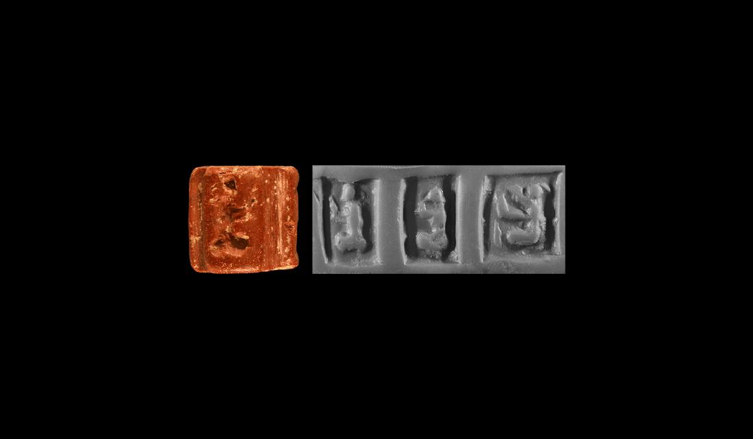 Mesopotamian Seal with Squatting Women: Circa 3000 BC. A carved red limestone cylinder seal depicting three women, accompanied by a museum quality impression and a typed, signed scholarly note by W.G. Lambert, Professor of Assyriology at th