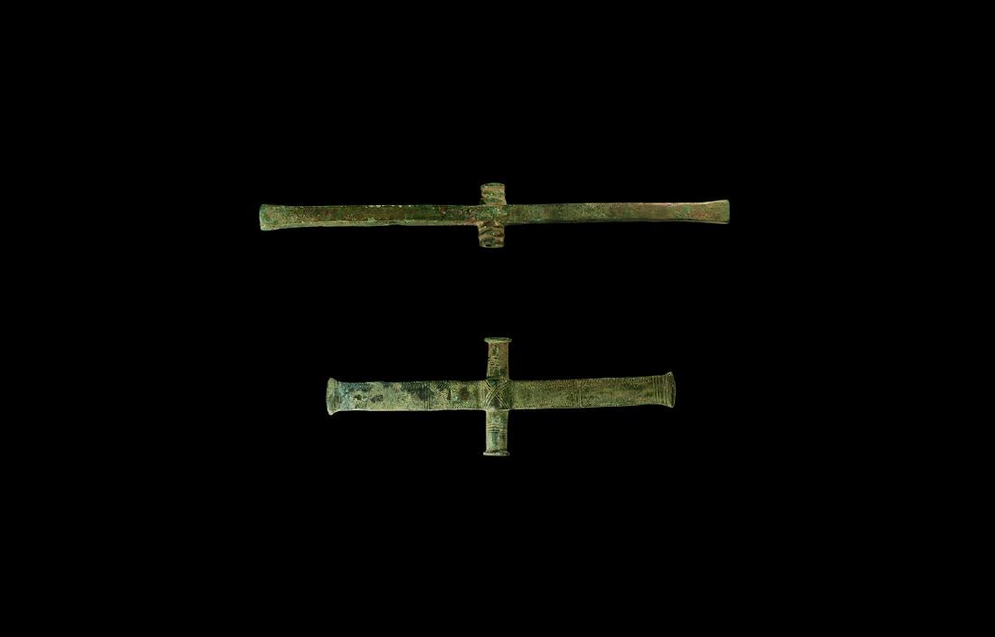 Bronze Age Sceptre Element Group: 2nd millennium BC. A group of two bronze sceptre elements(?) comprising: a tubular section with rims to both ends, transverse rectangular bar with clubbed ends, incised geometric ornament; one similar