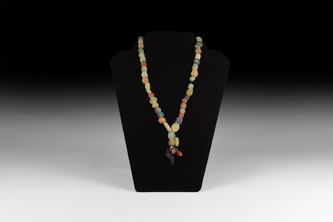 Viking Glass and Stone Bead Necklace: 9th-11th century AD. A restrung necklace of spherical, oblate and other beads in glass, carnelian, lapis lazuli and other materials. 92 grams, 50cm (19 3/4"). Property of a North West London gallery; 