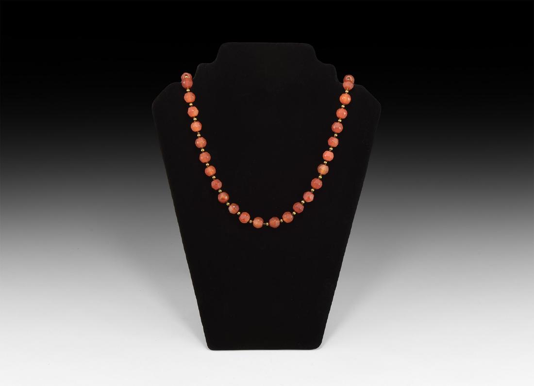Islamic Facetted Carnelian Bead Necklace: 18th-19th century AD. A restrung necklace of polyhedral carnelian beads with interstitial gold-coloured metal beads. 38 grams, 42cm (16 1/2"). Private collection, North London; acquired in the early 1