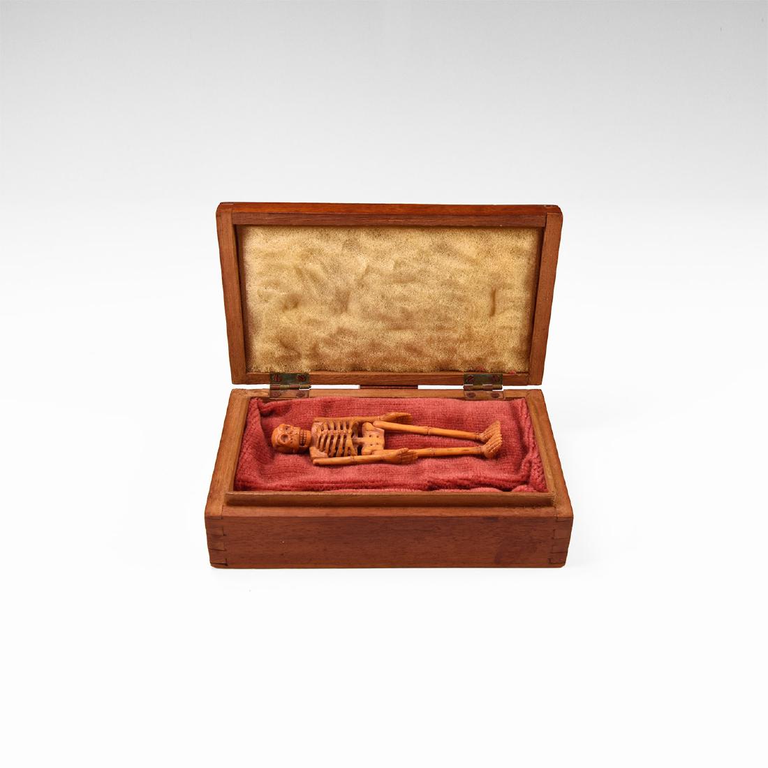Jacobean Bone Skeleton Model: 17th century AD. A carved bone articulated skeleton model with openwork detailing to the ribs, pelvis and skull; originally kept in a model coffin, now in later chip-carved wooden box. Skeleton: 12 gr