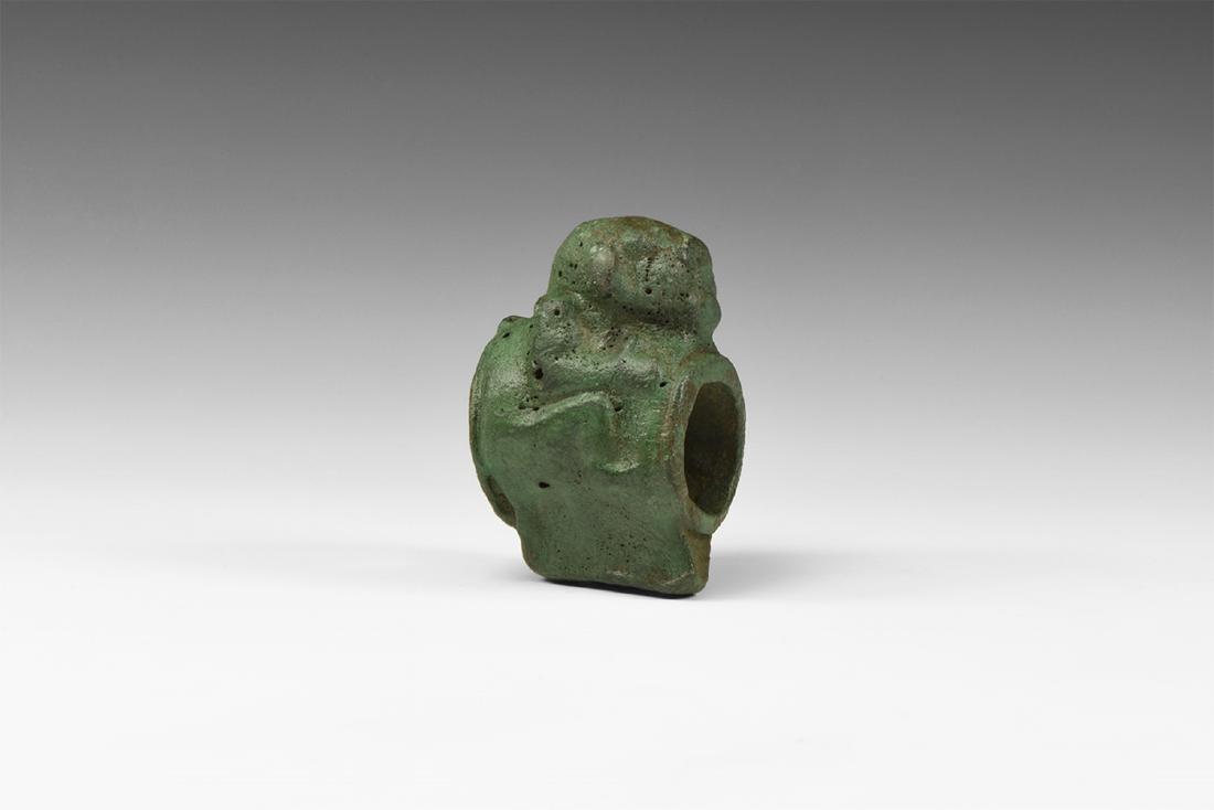 Elamite Macehead with Crouching Monkey: 2nd millennium BC. A bronze macehead in the form of a crouching monkey, hands and feet grasping the rim of the socket hole. 384 grams, 72mm (3"). The property of an English gentleman; formerly in a Ge