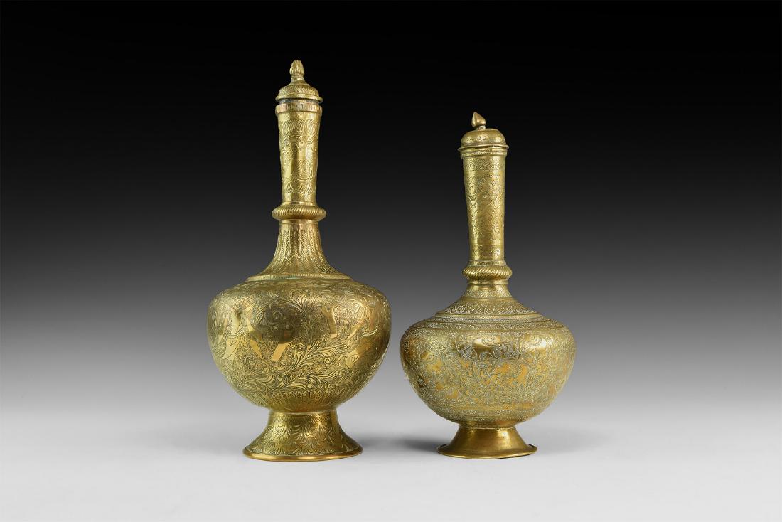 Islamic Brass Flask Pair: 20th century AD. A pair of bronze flasks each with flared base, bulbous body and tall slender neck, dome lid with knop handle, bands of low-relief floral and other ornament. 1.2 kg, 24-28cm (9 1/2 - 1
