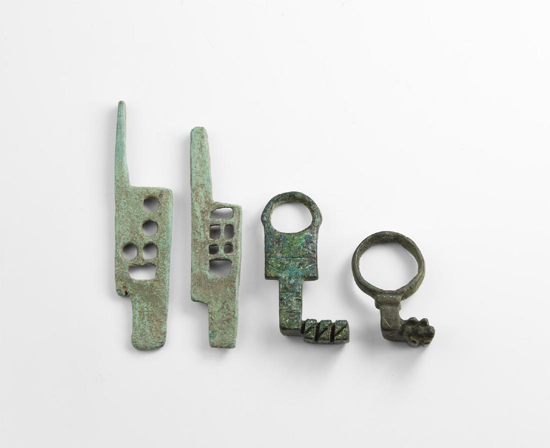 Roman Key and Lock Plate Group: 2nd-3rd century AD. A mixed bronze group comprising: two small keys each with a large bow, short shank, bit with teeth to the forward edge; two lock plates with voids and latch mechanism. 60.5 grams t