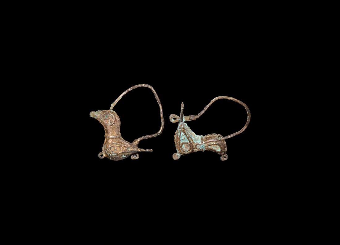 Islamic Fatimid Silver Bird Earrings: 10th-12th century AD. A pair of silver earrings in the shape of birds with filigree decoration to the body in the form of spirals; hoop to the tail and head. 6.70 grams, 30-35mm (1 1/4 - 1 1/2"). From