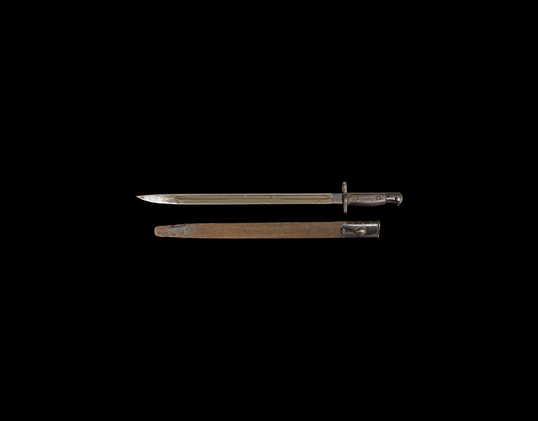 WWI British Sanderson Bayonet with Scabbard: Early 20th century AD. A Sanderson second model pattern 1907 bayonet of World War I period with fullered blade, steel hilt with locking latch and wood scales, the quillon with rifle muzzle aperture, w