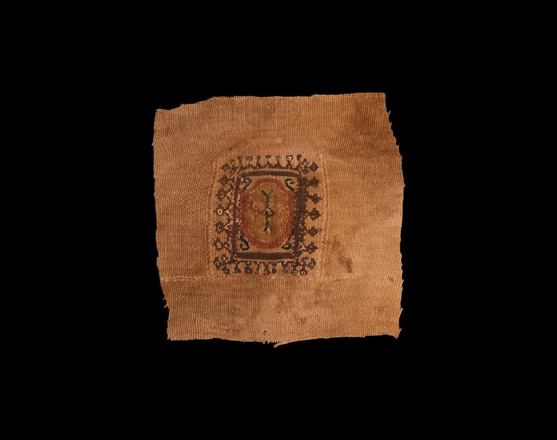 Coptic Panel with Embroidered Cross: 3rd-6th century AD. A decorative textile panel with foliage border and central polychrome rosette. 10 grams, 14cm (5 1/2"). Ex an important central London collection; previously acquired before 1990. 