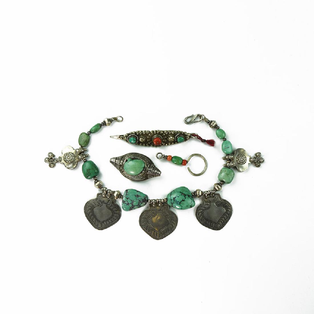 Tibetan Jewellery Group: 20th century AD. A mixed group comprising: a necklace with graduated irregular turquoise(?) beads with base metal spacers and plaques; an earring with turquoise(?) and carnelian(?) beads; a boat-shape
