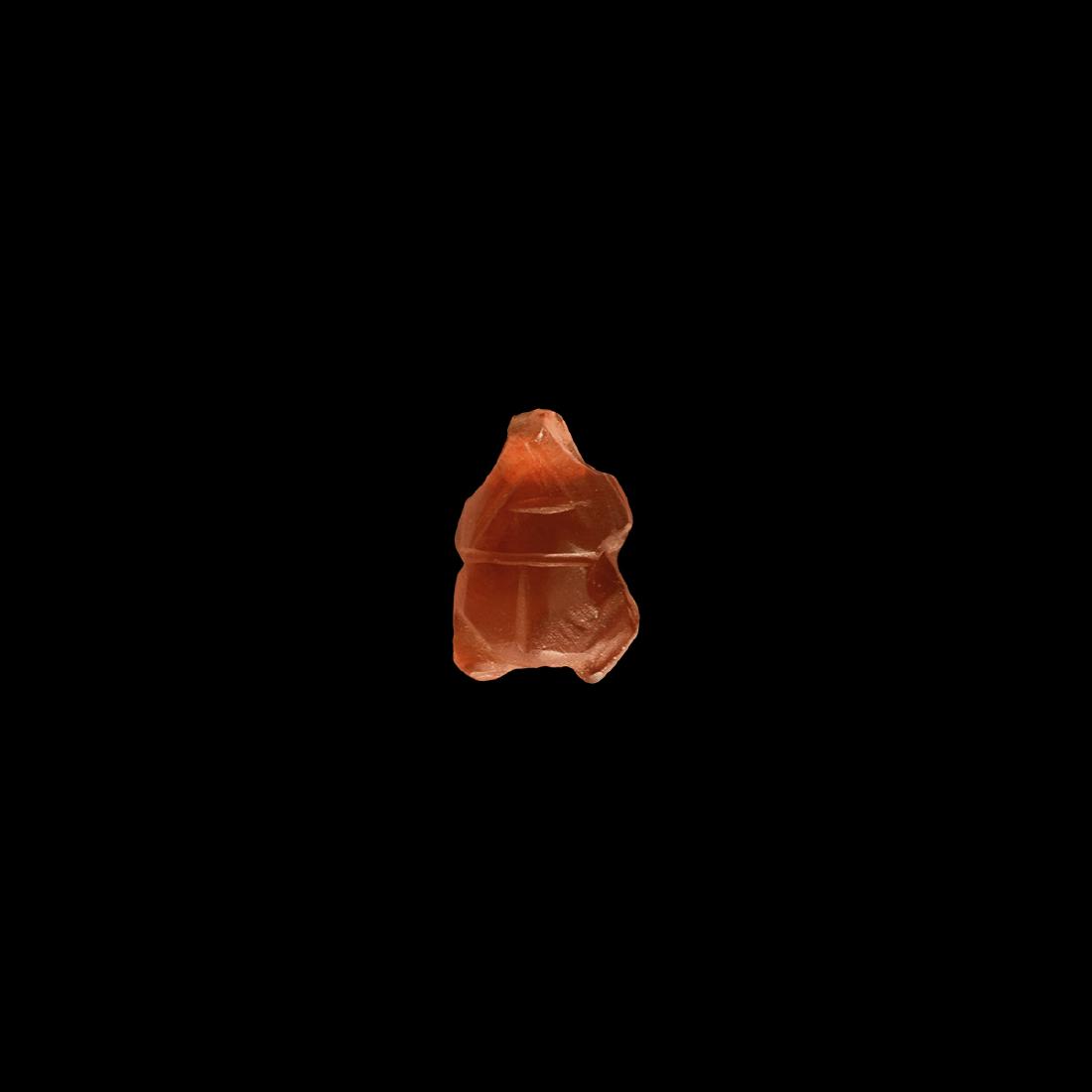 Egyptian Carnelian Scarab Pendant: New Kingdom, 1550-1070 BC. A carnelian scarab pendant with incised detailing to the carapace, suspension loop above. 0.57 grams, 14mm (1/2"). Property of a North London gentleman; acquired on the UK a