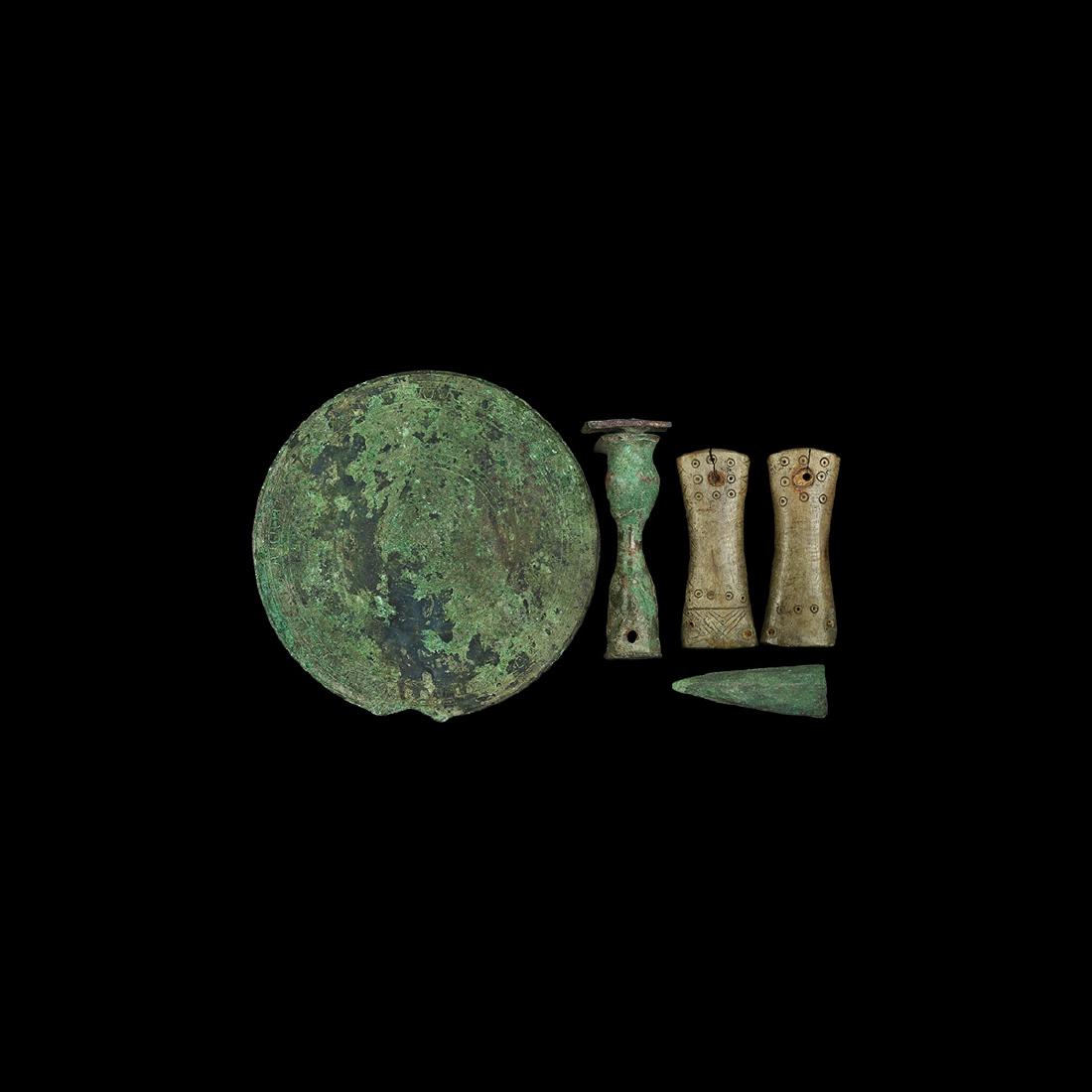 Roman Mirror and Other Artefact Group: Mainly 1st-2nd century AD. A mixed group comprising: a discoid bronze mirror with one polished face, concentric rings and lotus-leaf band to the reverse; a conical bronze spear(?) ferrule; a waisted b