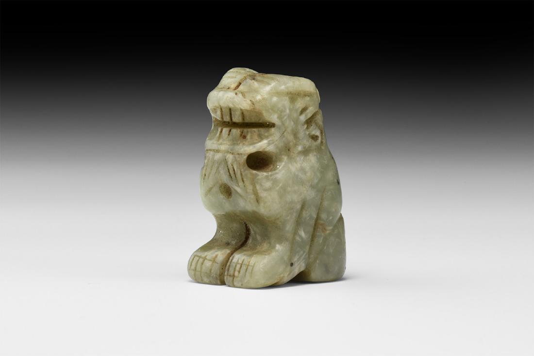 Chinese Carved Jade Lion: 19th century AD. A carved jade figurine of a lion squatting, modelled in the round with gaping mouth and curled mane, suspension loop beneath the chin. 31 grams, 37mm (1 1/2"). From the collection of 